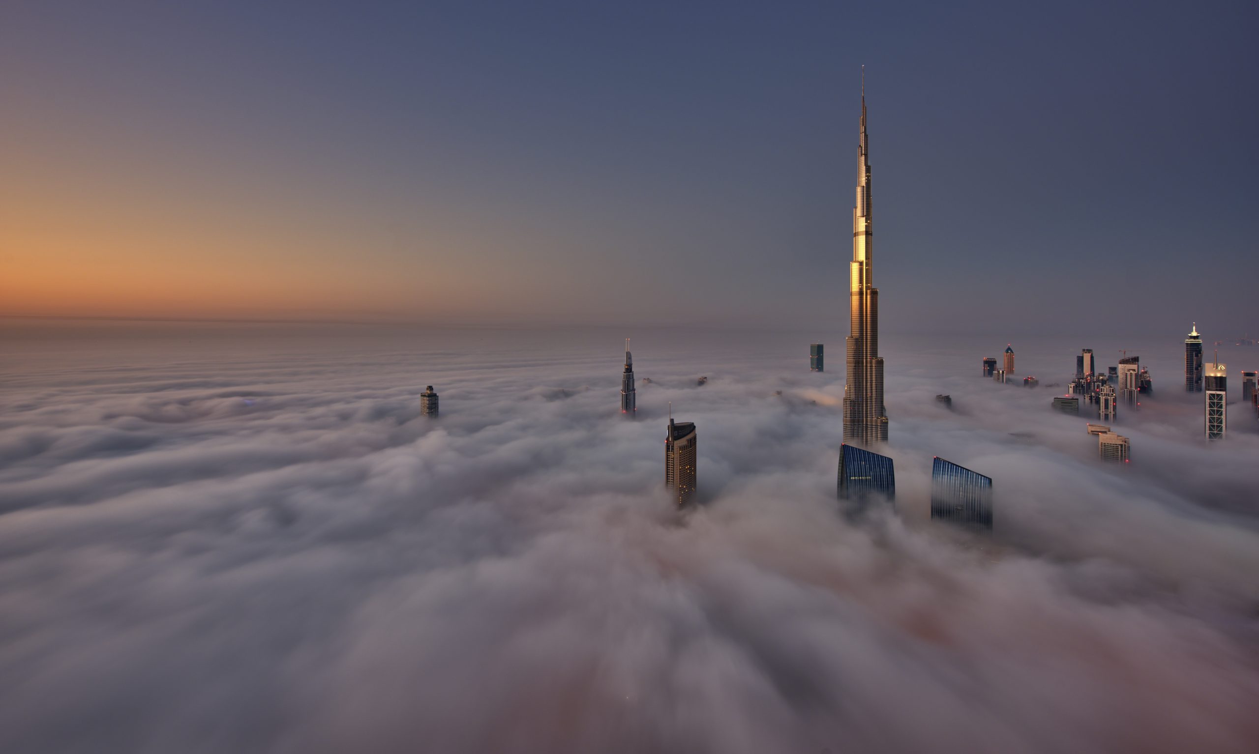 View of the Burj Khalifa and other skyscrapers above the clouds in Dubai, United Arab Emirates.,Dubai, United Arab Emirates
